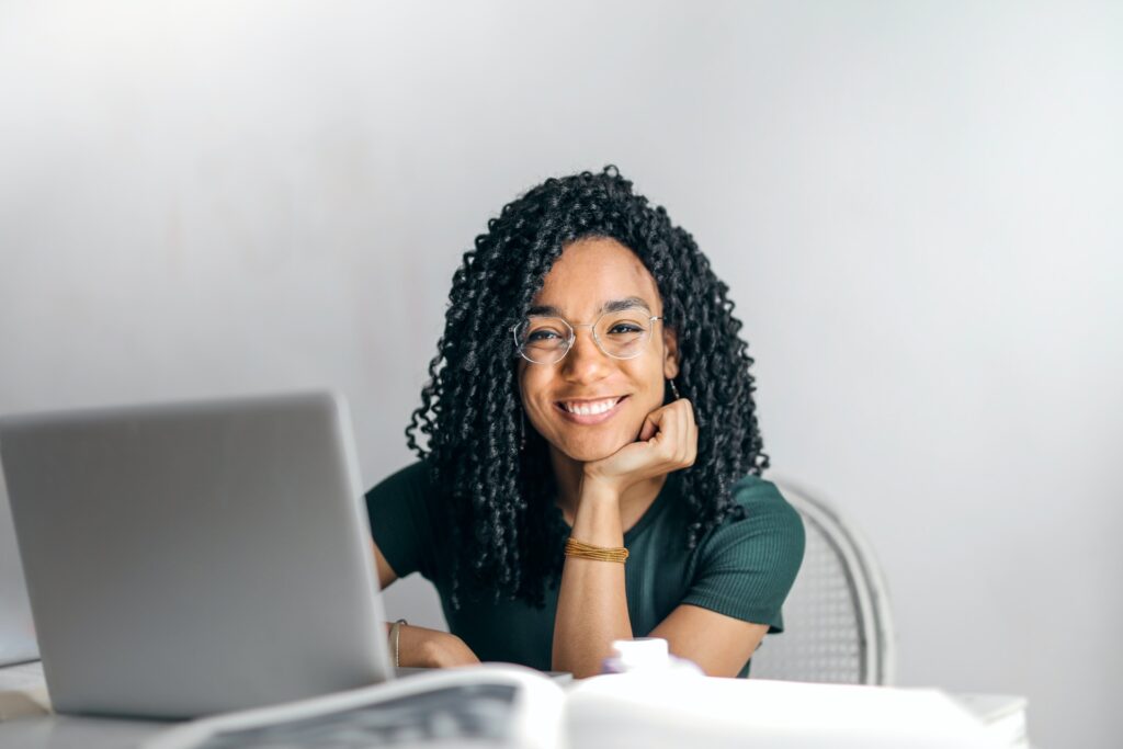 woman sitting by a laptop