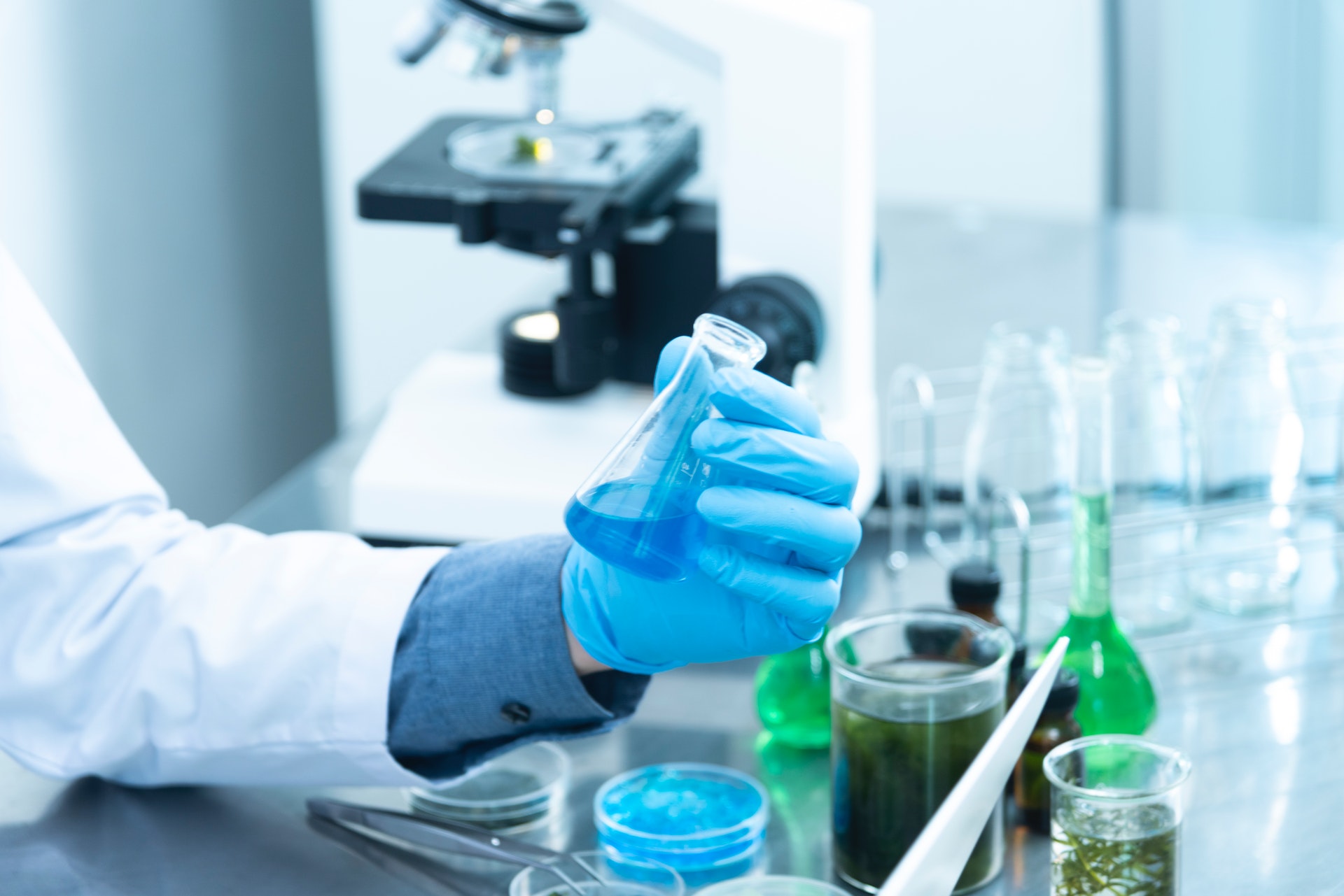 person getting ready for chemistry tutoring holding lab flask